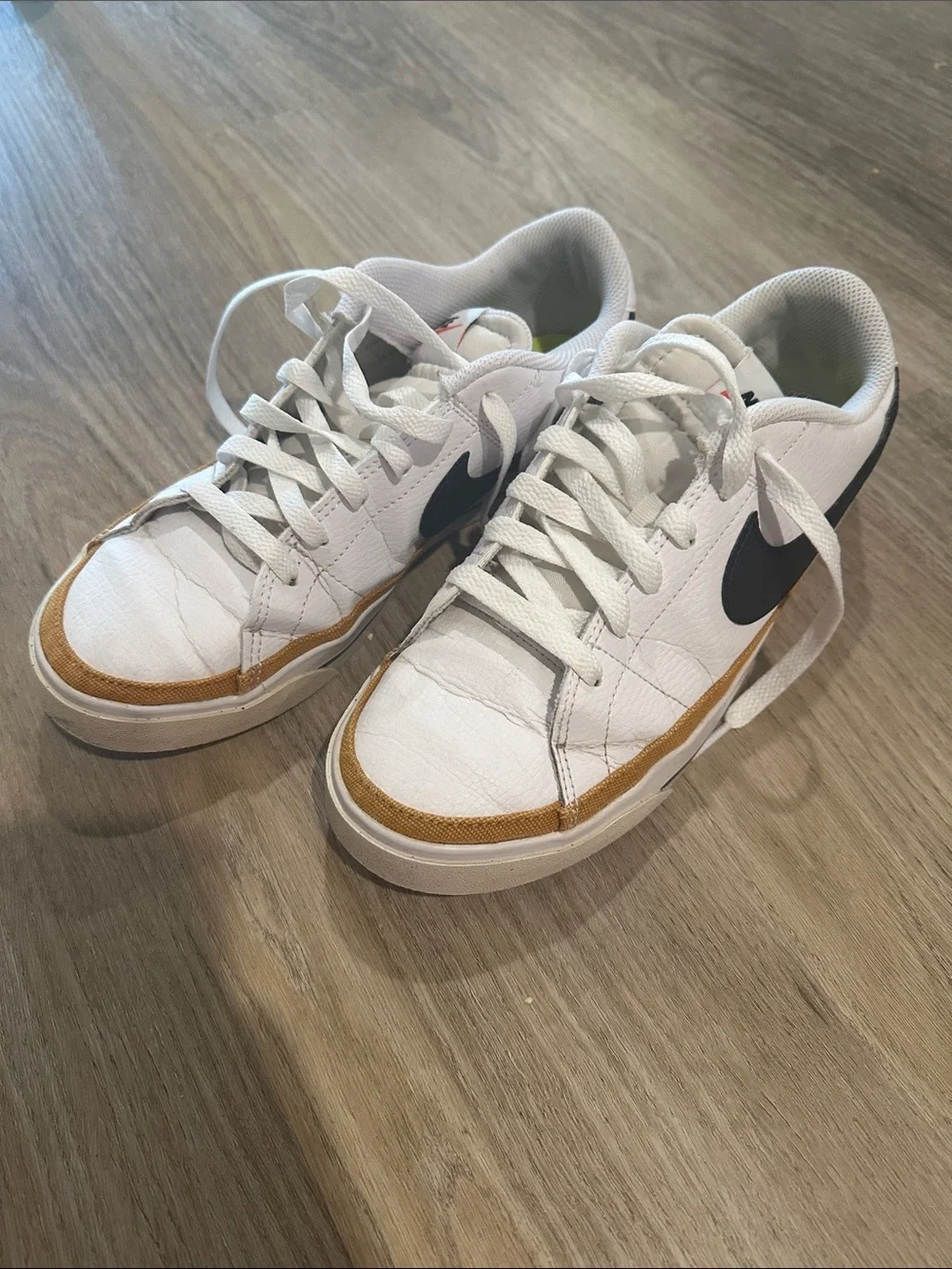 Nike White Low-Top Sneakers with Black Swoosh and Tan Trim court legacy